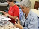 Teachers at the 2014 Dayton TI-1 session assemble the Boe-Bot® robot, which they will use to learn microcontroller programming and robotics.